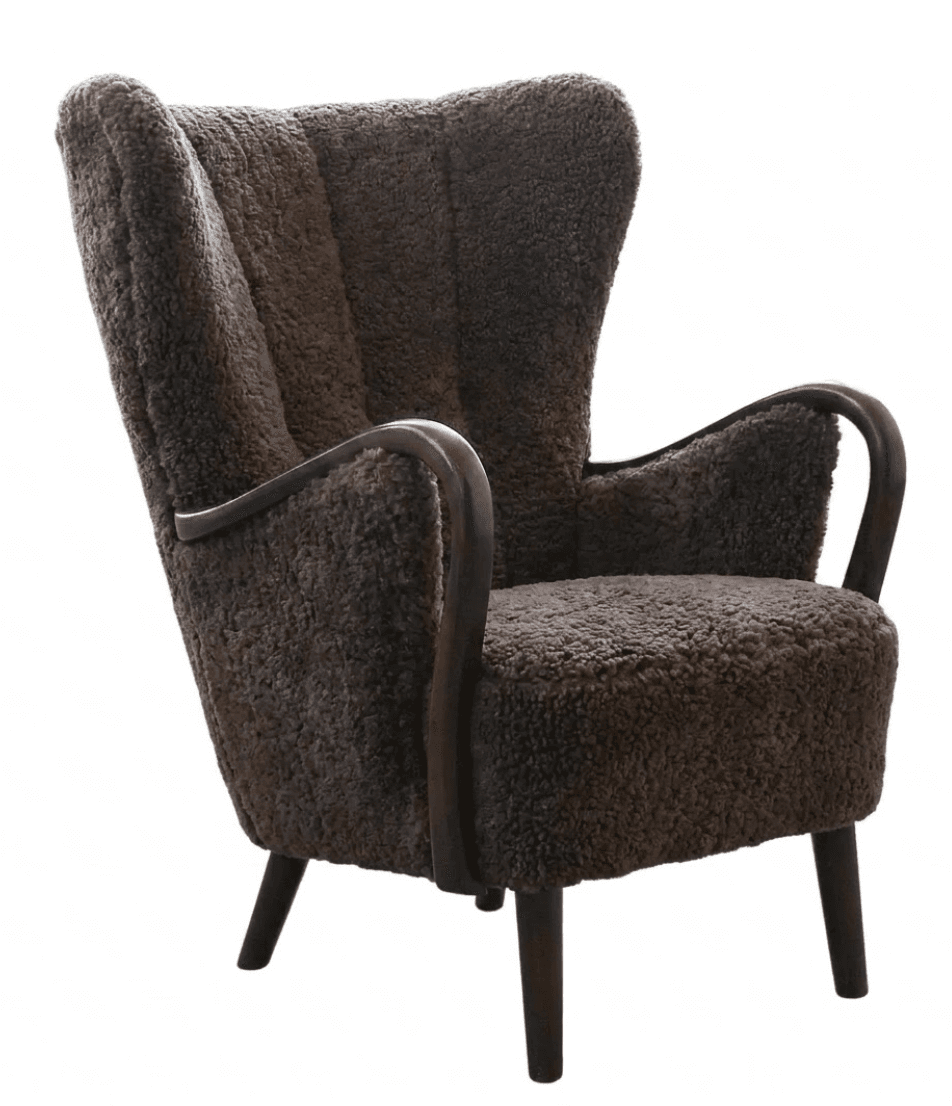A dark brown upholstered armchair with a high back and curved wooden armrests. The upholstery appears to be a textured, possibly sheepskin or faux fur material, with vertical channel tufting on the backrest. The chair has four tapered wooden legs. — 3D model