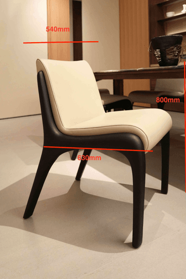A low-profile, armless chair featuring a dark stained wooden frame that forms integrated legs and back support, complemented by a cream-colored upholstered seat and backrest. — 3D model