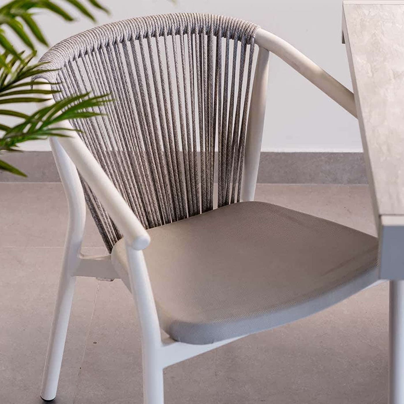 A modern armchair with a white frame and a woven rope backrest. It features a cushioned seat in a light grey fabric. The armrests are integrated into the frame, and the legs are slender and cylindrical. — 3D model