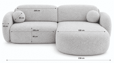 An L-shaped contemporary sectional sofa featuring soft, rounded contours and upholstered in a light, textured fabric, accompanied by two spherical accent cushions. — 3D model