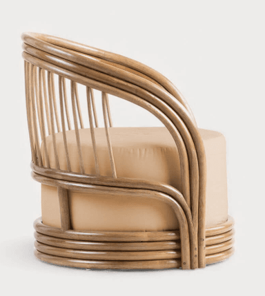 A barrel-shaped armchair constructed primarily from bentwood or cane, featuring a rounded backrest formed by vertical spindles connected to a top and bottom circular frame. The seat and lower body are upholstered in a light tan fabric. The base has subtle feet or glides. — 3D model