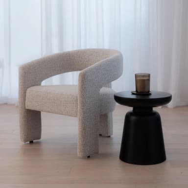 A modern armchair with a curved backrest and straight arms. The chair is upholstered in a textured fabric and features sturdy, rectangular legs. — 3D model