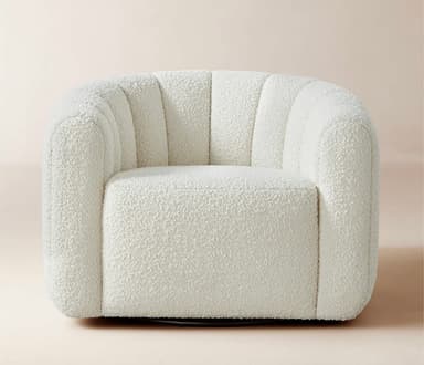 An off-white, channel-tufted bouclé swivel barrel chair. The chair features a rounded, plush design with vertical channel tufting along its backrest and armrests, which form a continuous curve. It is upholstered in a textured bouclé fabric and sits on a discrete swivel base, allowing for 360-degree rotation. The overall aesthetic is contemporary and inviting. — 3D model