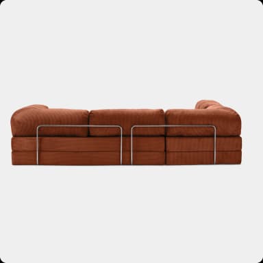 A modular sofa with a linear design, featuring stacked rectangular cushions upholstered in a corduroy-like fabric. The sofa is supported by a polished metal frame that runs horizontally along the front and sides, creating a distinct aesthetic. The cushions appear to be generously filled and have a soft, plush texture. The overall structure suggests a contemporary or mid-century modern style. — 3D model