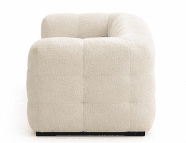A modern three-seater sofa upholstered in a creamy, off-white boucle fabric. The sofa features a distinctive tufted design, creating a plush, segmented appearance across the backrest, seat, and arms. It has low, rounded arms and a solid, block-style base in black or dark brown, providing a contemporary aesthetic. — 3D model