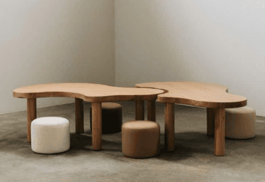 A set of two light-toned wooden tables with organic, irregular-shaped tops and thick cylindrical legs, designed to be used together as a cohesive unit. — 3D model