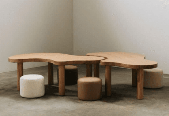 A set of two light-toned wooden tables with organic, irregular-shaped tops and thick cylindrical legs, designed to be used together as a cohesive unit. — 3D model