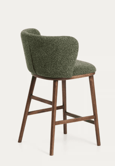 A bar stool with a curved, upholstered backrest and seat, supported by four wooden legs connected by a footrest. The stool features a textured, greenish-brown fabric for the seating and backrest, and a dark wood finish for the frame. — 3D model