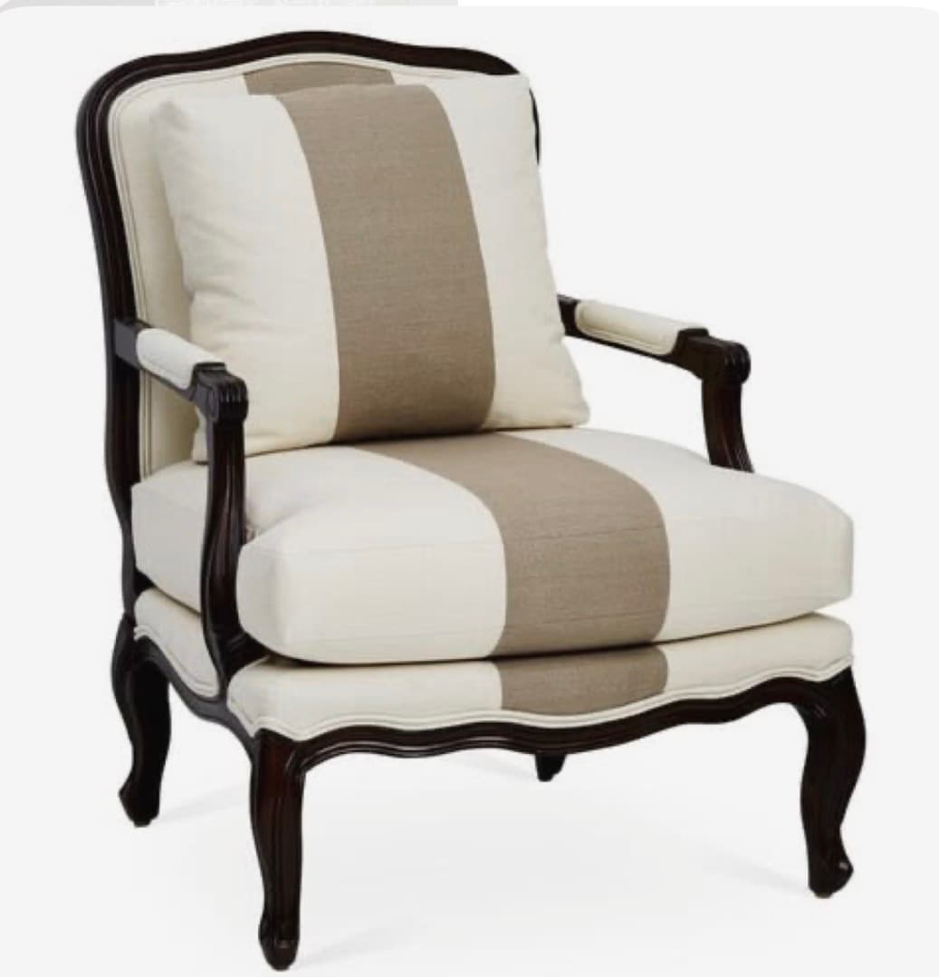 An elegant armchair featuring an exposed, dark-stained carved wooden frame with ornate details, upholstered in a cream and beige striped fabric. It has a loose seat cushion and a back cushion, both matching the striped pattern. The chair stands on classic cabriole legs. — 3D model