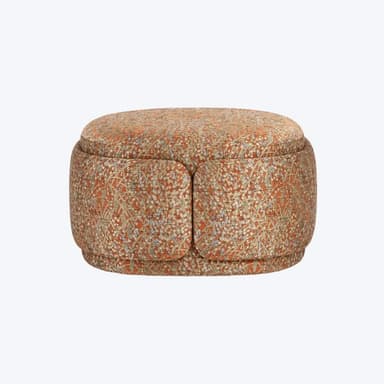 A round, upholstered storage ottoman featuring a rich, intricate pattern primarily in shades of orange, cream, and blue. The ottoman has a distinct two-part top, suggesting an internal storage compartment. Its base is subtly recessed, giving it a slightly floating appearance. The fabric's design combines floral or botanical elements with geometric motifs. — 3D model