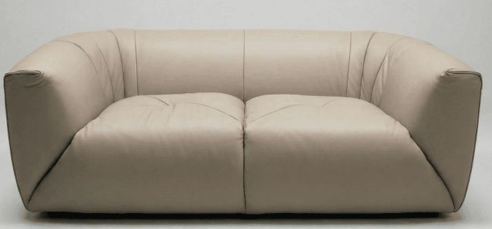 A modern two-seater sofa upholstered in light beige leather, featuring a plush, rounded design with a low profile. The backrest shows subtle vertical channeling, and the two individual seat cushions have a gentle tufted appearance. The overall form is volumetric and fluid. — 3D model