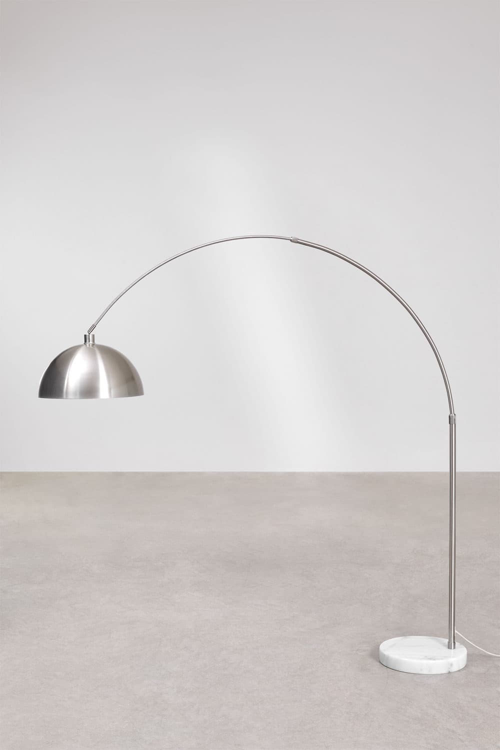 A modern arc floor lamp featuring a brushed stainless steel finish and a heavy white marble base. The tall, slender arched arm extends significantly, culminating in a semi-spherical dome-shaped shade made of the same brushed metal. The lamp provides overhead illumination, often used to project light over a seating area or table. The design is minimalist and contemporary. — 3D model