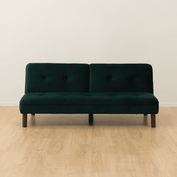 A dark emerald green velvet futon sofa bed with button tufting on the backrest and seat, supported by tapered wooden legs. — 3D model