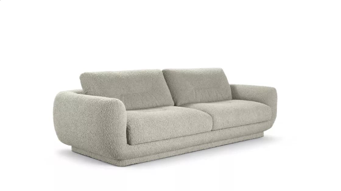 A two-seater sofa upholstered in a light-colored, textured boucle fabric, featuring a contemporary design with rounded arms and a plinth base. — 3D model