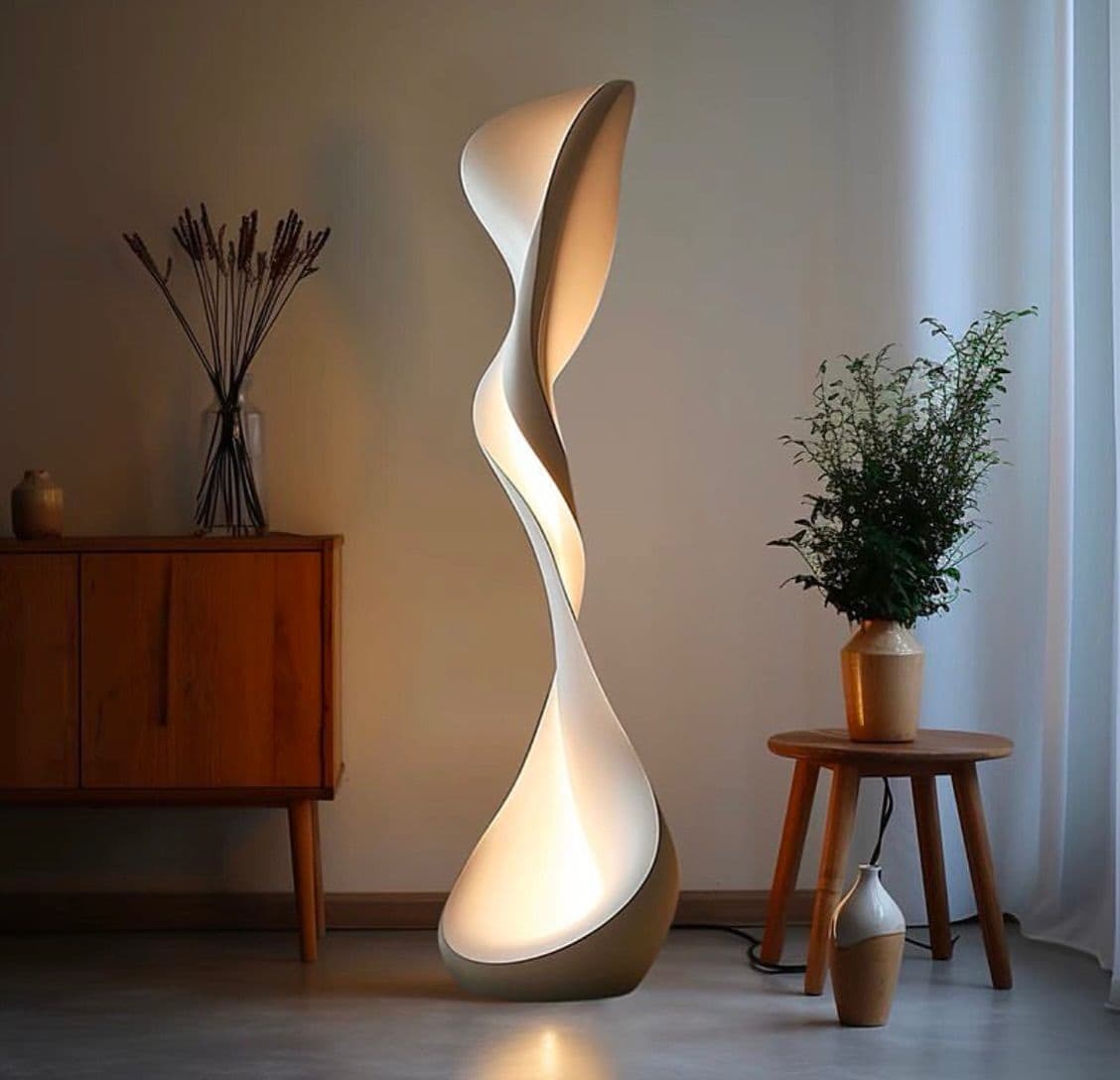 A tall, contemporary floor lamp featuring a sculptural, twisted design. The lamp's body is a continuous, ribbon-like form that gently twists upwards, creating an elegant, biomorphic silhouette. Light emanates softly from the inner curves of the twisted structure, providing ambient illumination. The exterior appears to have a smooth, matte finish in a bronze or deep champagne color, contrasting with the lighter, illuminated interior. — 3D model