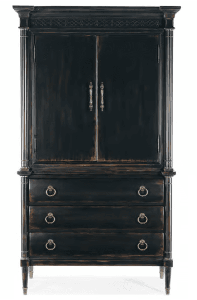 A tall, dark wood armoire with two doors on the upper section and three drawers on the lower section. The armoire features decorative molding at the top, fluted columns on the sides of the upper section, and ring-pull hardware on the drawers. The finish appears distressed, with lighter wood tones showing through the dark paint, suggesting an antique or distressed style. It stands on four tapered legs. — 3D model