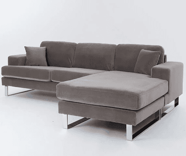 A plush, grey sectional sofa with a chaise lounge extension. The sofa features a modern design with clean lines and supportive back cushions. It is supported by sleek, polished metal legs. — 3D model