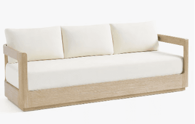 A three-seater sofa with a light wood frame and off-white cushions. The frame has a clean, minimalist design with straight lines. The seat and back cushions appear to be upholstered in a fabric. — 3D model