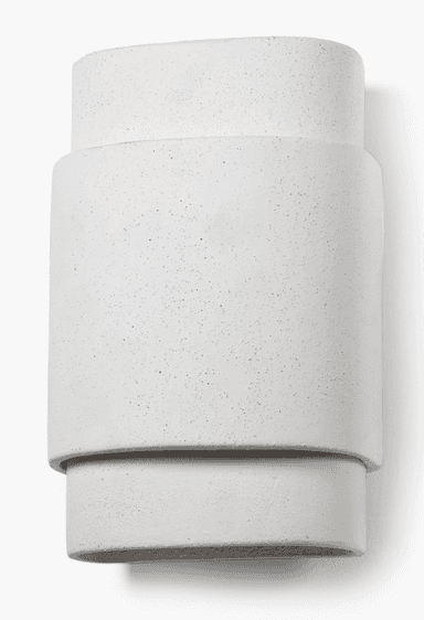 A minimalist wall-mounted lighting fixture, likely a sconce, featuring a stacked oval design. The object appears to be made from concrete or a similar textured, light-grey composite material. It consists of a larger central oval section, flanked by a slightly smaller, shallower oval section at the top and bottom, creating a layered, three-dimensional effect. The surfaces are uniformly textured with a speckled, raw concrete finish. The design suggests an upward and/or downward light projection, characteristic of modern architectural lighting. — 3D model