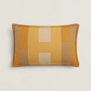 A rectangular decorative throw pillow featuring a geometric pattern composed of blocks of color in varying shades of yellow, beige, and light brown. The pillow has piped edges in a solid tan color, suggesting a finished, tailored look. The fabric appears to be a woven textile, possibly wool or a blend, with a visible texture. — 3D model