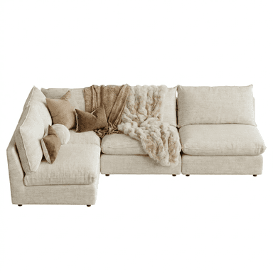 An L-shaped modular sectional sofa in a light, neutral fabric, featuring deep seats and plush back cushions for a relaxed aesthetic. It includes an integrated chaise lounge on one end, providing extended seating. Two throw blankets, one textured and one fur-like, along with two accent pillows, are draped across the sofa, suggesting comfort and warmth. The design is modern and minimalist, with clean lines and low-profile arms. — 3D model