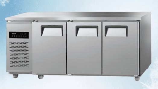 A commercial-grade, undercounter refrigerator with a stainless steel exterior. It features a flat top surface and three doors with integrated recessed handles. The left side of the unit has a digital display panel and a grated vent, indicating cooling or ventilation components. The appliance rests on short, cylindrical legs. — 3D model
