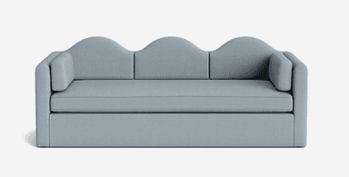 A light blue upholstered sofa with a distinctive three-arched, wavy backrest. It features three seat cushions and two cylindrical bolster cushions acting as armrests. The sofa has a low-profile base. — 3D model