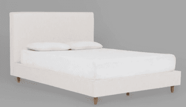 A minimalist upholstered platform bed featuring a rectangular headboard and a low-profile frame. The bed is covered in an off-white or cream-colored fabric and stands on four light-toned, tapered wooden legs. A mattress and two white pillows are present on the bed. — 3D model
