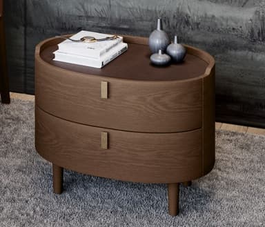 An oval-shaped nightstand with two drawers, featuring a dark wood finish and tapered legs. The top surface appears to be a darker, possibly lacquered wood or a contrasting material inset into the main body. Each drawer has a small, rectangular, light-colored handle. — 3D model