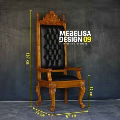 A highly ornate, traditional style armchair featuring a tall, upholstered backrest and seat. The wooden frame is intricately carved with decorative motifs, especially prominent on the crest rail of the back and the cabriole legs. The upholstery appears to be black tufted faux leather, contrasting with the rich brown wood finish. The chair has padded armrests and finials on the top corners of the backrest, contributing to its ceremonial or formal aesthetic. — 3D model