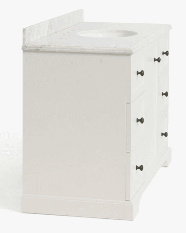 A white painted bathroom vanity featuring a white marble countertop with an integrated oval sink. The vanity cabinet has a central door and six drawers, three on each side, all adorned with small brass knobs. The cabinetry features recessed panel fronts, and the base has a simple decorative cut-out. — 3D model