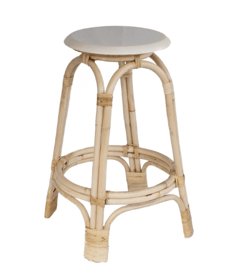 A natural rattan bar stool featuring a round, light-colored solid seat. The base consists of curved rattan poles forming four splayed legs, with additional curved rattan pieces creating a circular footrest towards the bottom. The rattan elements are secured together with visible woven rattan bindings. — 3D model
