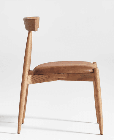 A modern dining chair constructed from light-toned oak wood with a brown leather upholstered seat. The chair features a minimalist design with tapered legs, a subtly curved backrest, and a sturdy wooden frame. — 3D model