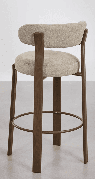 A contemporary bar stool featuring a dark wood frame, an upholstered seat, and a contoured upholstered backrest. It includes a circular metal footrest for comfort and stability. — 3D model