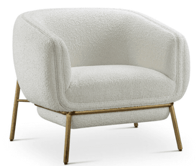 A contemporary lounge chair featuring a plush, rounded form upholstered in off-white boucle fabric, supported by a minimalist gold-toned metal frame. The frame includes slender legs and a distinctive horizontal band wrapping around the upper backrest. — 3D model