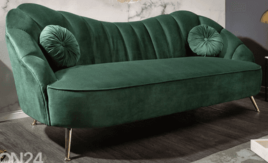A dark green velvet sofa with a sculpted, fluted backrest and curved armrests. It features two round, tufted throw pillows. The sofa is supported by four slender, angled legs with a brass finish. — 3D model
