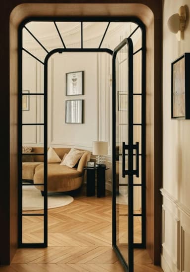 An arched wooden door with a black metal frame and glass panels. The door features a prominent arch at the top and two vertical handles. — 3D model