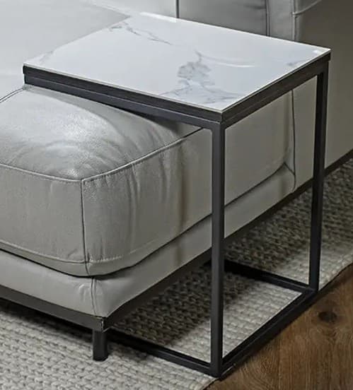 A C-shaped end table designed to slide under a sofa or chair. It features a rectangular top with a marbled pattern, supported by a thin, dark metal frame with a cantilevered design. — 3D model