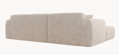 A modular sectional sofa with a chaise lounge extension. The sofa features plush, rounded armrests and a backrest divided into three distinct segments. It is upholstered in a textured fabric and includes two square throw pillows with ribbed detailing. The chaise is integrated seamlessly into the left side of the sofa as viewed from the front. — 3D model