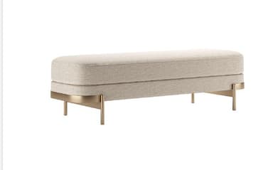 A long, upholstered bench with a two-tiered seat cushion. The bench is supported by a metallic, minimalist base with four slender legs. The base has a curved design element that wraps around the sides of the seat. — 3D model
