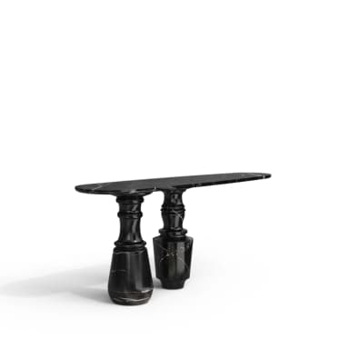 A sophisticated and sculptural console table crafted entirely from black marble with prominent white veining. It features an elongated oval tabletop supported by two distinct, heavily carved baluster-style pedestals, giving it a strong, classical yet contemporary presence. — 3D model