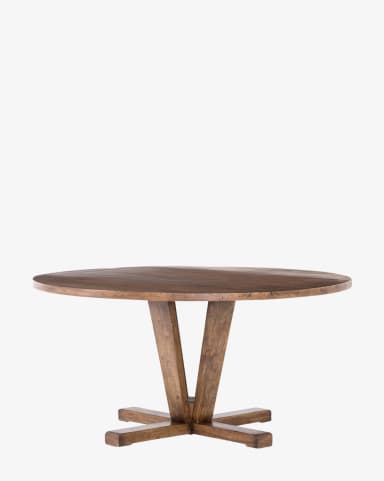A round dining table with a dark wood finish. The table features a thick, solid top with a slightly irregular edge, suggesting a natural or handcrafted aesthetic. The pedestal base consists of a central vertical support from which angled legs extend outwards and downwards, terminating in a horizontal stretcher base that provides stability. The overall design appears robust and substantial. — 3D model