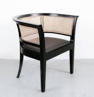 An elegant armchair featuring a black wooden frame with a curved backrest and natural cane webbing. The seat appears to be upholstered in a dark material, likely black leather or fabric. The chair has a classic yet versatile design. — 3D model