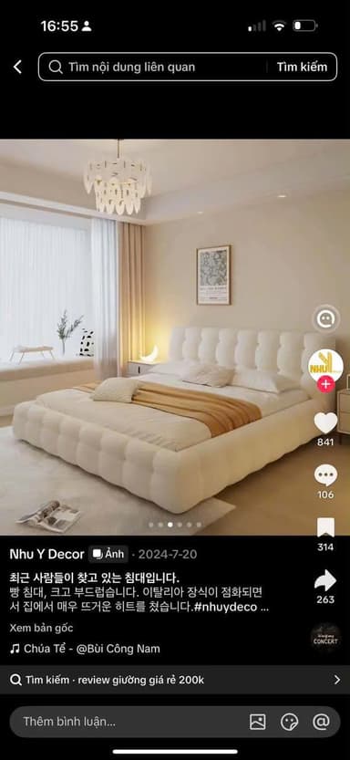 A modern platform bed featuring a distinctive upholstered design with soft, bulbous sections forming both the headboard and the surrounding frame, in a light, textured fabric. — 3D model