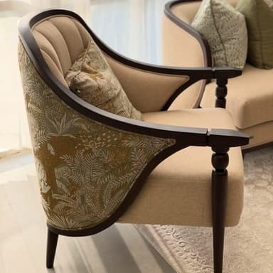 An upholstered armchair featuring an exposed dark wood frame, a beige fabric seat and inner back, and a patterned fabric on the outer back. The inner back is channel tufted, and the front legs are turned. — 3D model