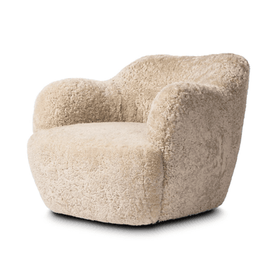 A plush armchair upholstered in a textured, curly, light beige material resembling sheepskin. The chair features a rounded silhouette with integrated armrests that flow into the backrest, and a deep, comfortable seat. The base is solid and integrated with the main body of the chair, lacking distinct legs. The overall design is compact and inviting. — 3D model