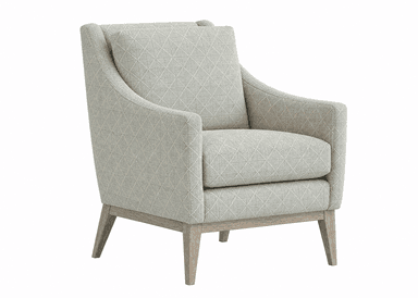 A upholstered armchair viewed from the rear. The chair features a high back with a slightly curved top edge and integrated armrests. The upholstery is a light grey fabric with a diamond-patterned weave in a lighter contrasting thread. The chair is supported by a wooden base and four tapered legs, appearing to be made of light-colored wood. — 3D model