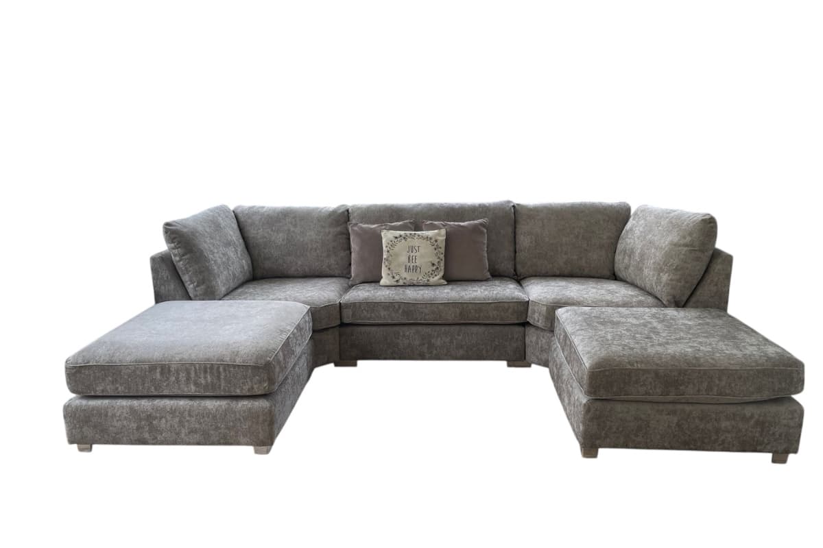 A large, U-shaped sectional sofa with plush cushioning and wide armrests. The sofa features multiple seating sections and two detachable chaises or ottomans, one on each end of the 'U'. It includes two decorative throw pillows. The sofa appears to be upholstered in a textured fabric. — 3D model