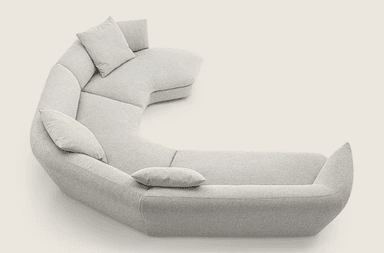 A sectional sofa with a curved, semi-circular configuration. It features multiple seating sections and includes four throw pillows. The overall design is modern and minimalist, with soft, rounded edges and a plush upholstery. — 3D model