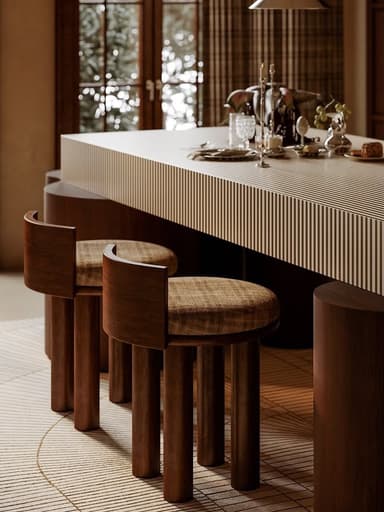 A stool with three cylindrical wooden legs supporting a circular padded seat. A short, curved wooden backrest extends upwards from the rear of the seat. — 3D model